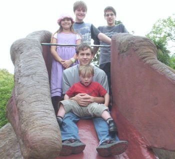 Jacob playing with his brothers and sister - kids with Down Syndrome enjoy play and playgrounds just like other kids