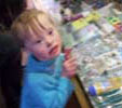 Jacob, a child with Down Syndrome, enjoying a family holiday and browsing in shops, like any other 5 year old child would