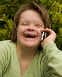 Adult woman with Down's syndrome using mobile phone