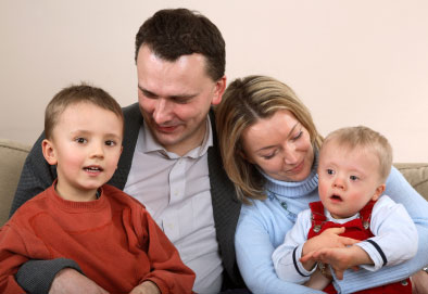 Down syndrome child with his family