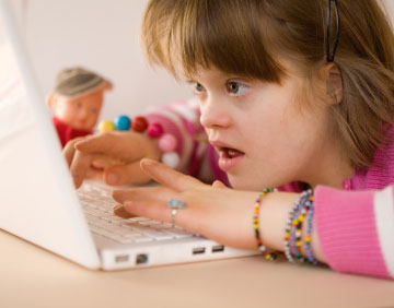 Girl with Down syndrome on laptop again