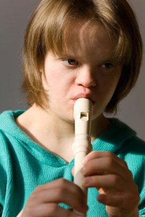 Girl with Down syndrome playing flute