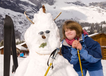 Older girl with down syndrome, with the snowman she made