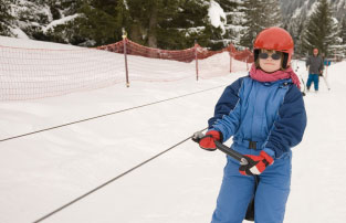 Older girl with Down's syndrome using ski lift