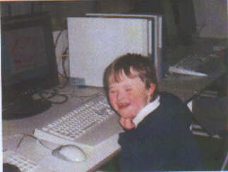 Jacob, aged 6 years, working on the school computer - kids with Down Syndrome normally love to work on computers.